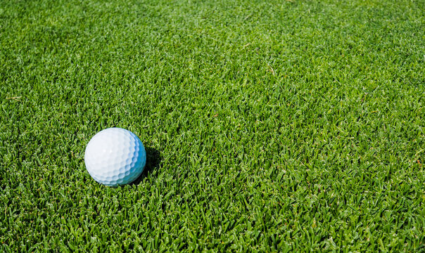 Golf balls on the green lawn, outdoor on the field