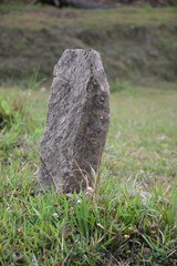 old stone cross on the grass