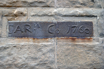 Cast Iron Plaques with Dates in Old Rough Stone Wall 