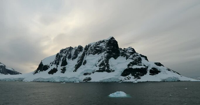 WS Lemaire Channel with snow covered mountain at sunset / Antarctica