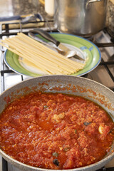 preparing tomato sauce for pasta