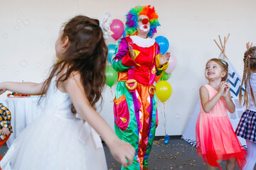 Children play with a clown