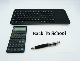 Computer keyboard, calculator, pen, isolated on white background. Back to school concept