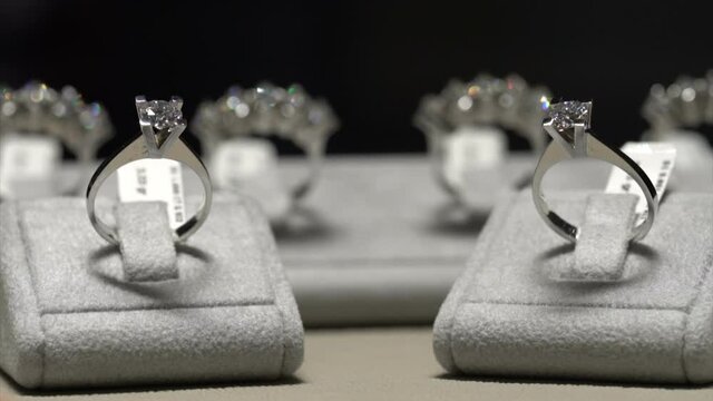 Diamond ring on the table in jeweler shop. Shine diamond solitaire rings black background close up macro shoot