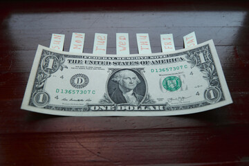 one dollar bill with stickers