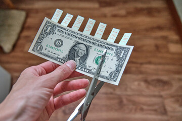 one dollar bill that a person wants to cut