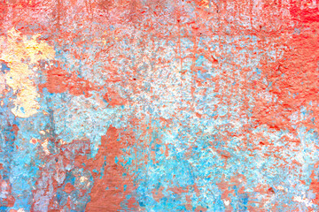 Old concrete wall covered with colorful paint.