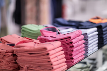 Large assortment of shirts displayed on shelves in men clothes shop