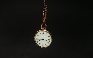 Old clock on a black background