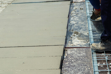 cement surface adjusting with hand of worker and waiting for cure by sunligth in out door in hands hold spong