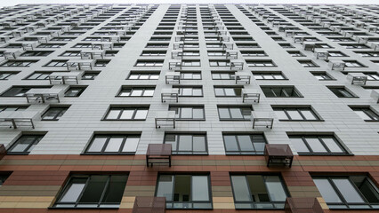 Diminishing perspective of window rows on facade of modern residential building in Moscow