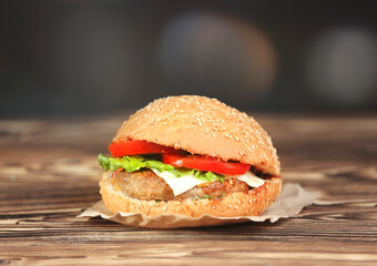 Hamburger on wooden table closeup.Burger on dark background.