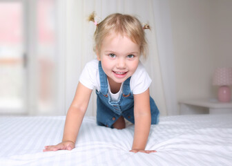Caucasian toddler portrait,healthy lifestyle concept.Kid in bedroom.Playfull happy child.