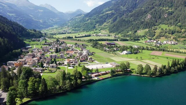Aerial 4K - Poschiavo valley, Switzerland, view of the village Le Prese from the Poschiavo lake	
