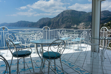 Fototapeta premium metal tables and chairs overlooking the sea in europe