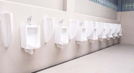 Men's toilet public with white porcelain urinals stall, Modern  clean bathroom for a pee