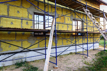 House thermal insulation mineral wool slabs. Inside wall heat isolation with mineral wool.
