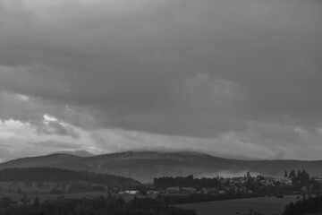 Black and white view for sunset in summer rainy evening near Roprachtice village