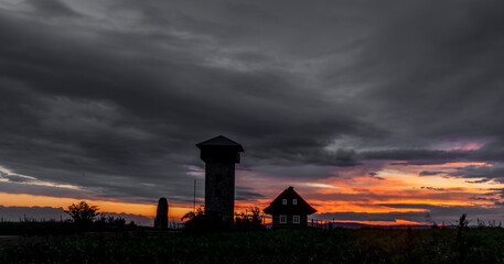 Sunset in summer rainy evening near Roprachtice village with observation tower