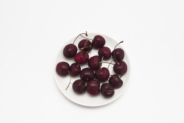 Fresh red Cherries on the dish isolated 