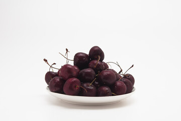 Fresh red Cherries on the dish isolated 
