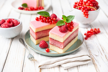 Delicious and refreshing juicy dessert, punch cake topped with sugar icing and fresh raspberries...