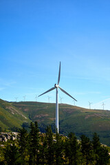 mountains with windmills and blue sky