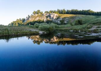 Fototapeta na wymiar early morning, the sun falls on the mountain, green forest, nature of Russia, Bashkortostan blue lake surroundings