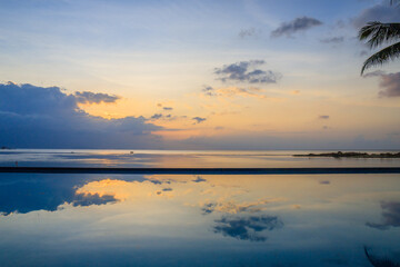 Blue and Orange sunset with a beautiful cloud reflexion over the water