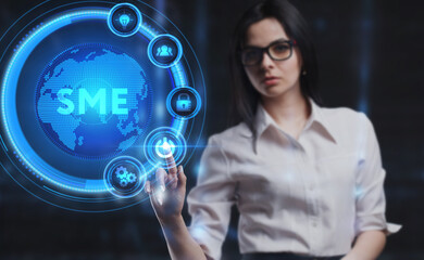 Business, Technology, Internet and network concept. Young businessman working on a virtual screen of the future and sees the inscription: SME