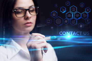 Business, Technology, Internet and network concept. Young businessman working on a virtual screen of the future and sees the inscription: Contact us