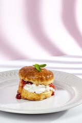 Assortment of homemade scones with ham, cheese, avocado, salmon, cream cheese and strawberry jam