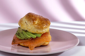 Assortment of homemade scones with ham, cheese, avocado, salmon, cream cheese and strawberry jam