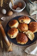 Raisin yeast buns. Overhead view, rustic style