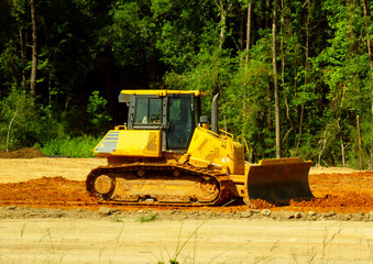 Bull dozer moving dirt at a construction site in Conroe, Texas. © Mark