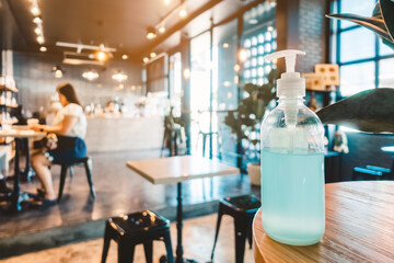 Blue alcohol gel bottle for hand cleaning to prevent the spreading of the Corona virus (Covid-19), Place the entrance service for customers  in the cafe. Healthcare concept.