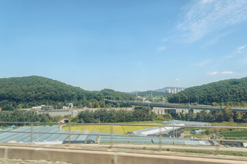 korean landscape with greenhouses and bridge view