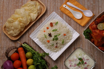 Veg pulav_chicken fry_wooden texture