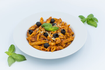  Penne pasta with chicken, olives and vegetables in red tomato sause 