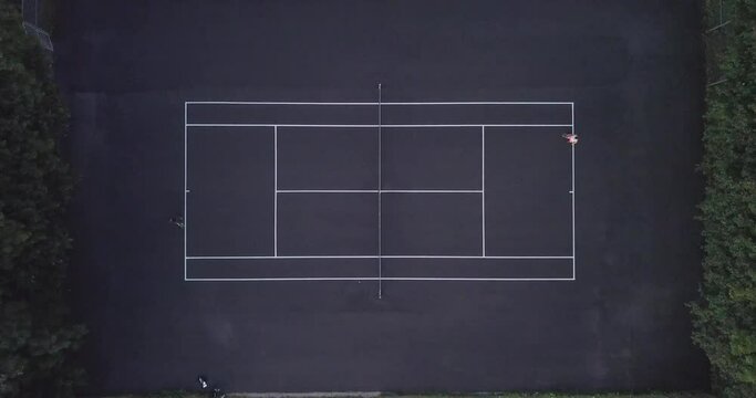 Aerial of People playing Tennis while Drone flies Higher