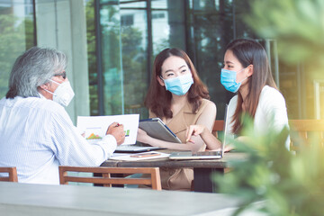 Group of people wearing masks and working together