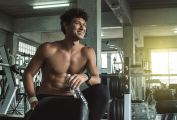 Fototapeta na wymiar Muscular man doing exercise in gym