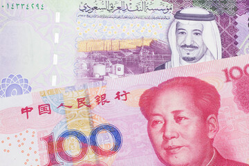 A close up image of a five riyal note from Saudi Arabia along with a one hundred yuan bank note from the People's Republic of China