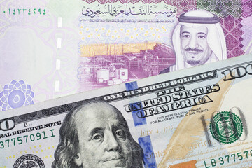 A one thousand Japanese yen bank note, close up in macro with a five riyal bank note from Saudi...