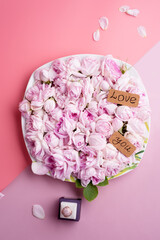 plate of pink roses  with ring around dounle pink  background. romantic and beauty concept
