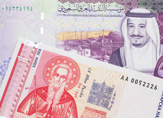A Bulgarian one lev bank note with a colorful five Saudi riyal bank note close up in macro