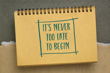 It is never too late to begin motivational reminder - handwriting in a spiral sketchbook, business or personal development concept