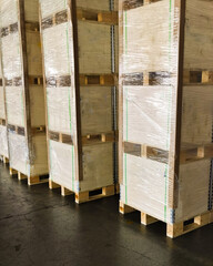 Shipment cartons box on pallets and wooden case on forklift in interior warehouse cargo for export and sorting goods in freight logistics and transportation industrial