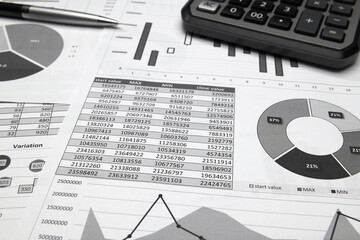 business office desk closeup - financial reports, analysis and accounting, set of documents, tables and graphs, various items for bookkeeping, calculator