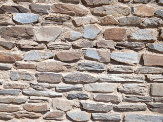 decorated stone wall in the garden of a villa in Sardinia
